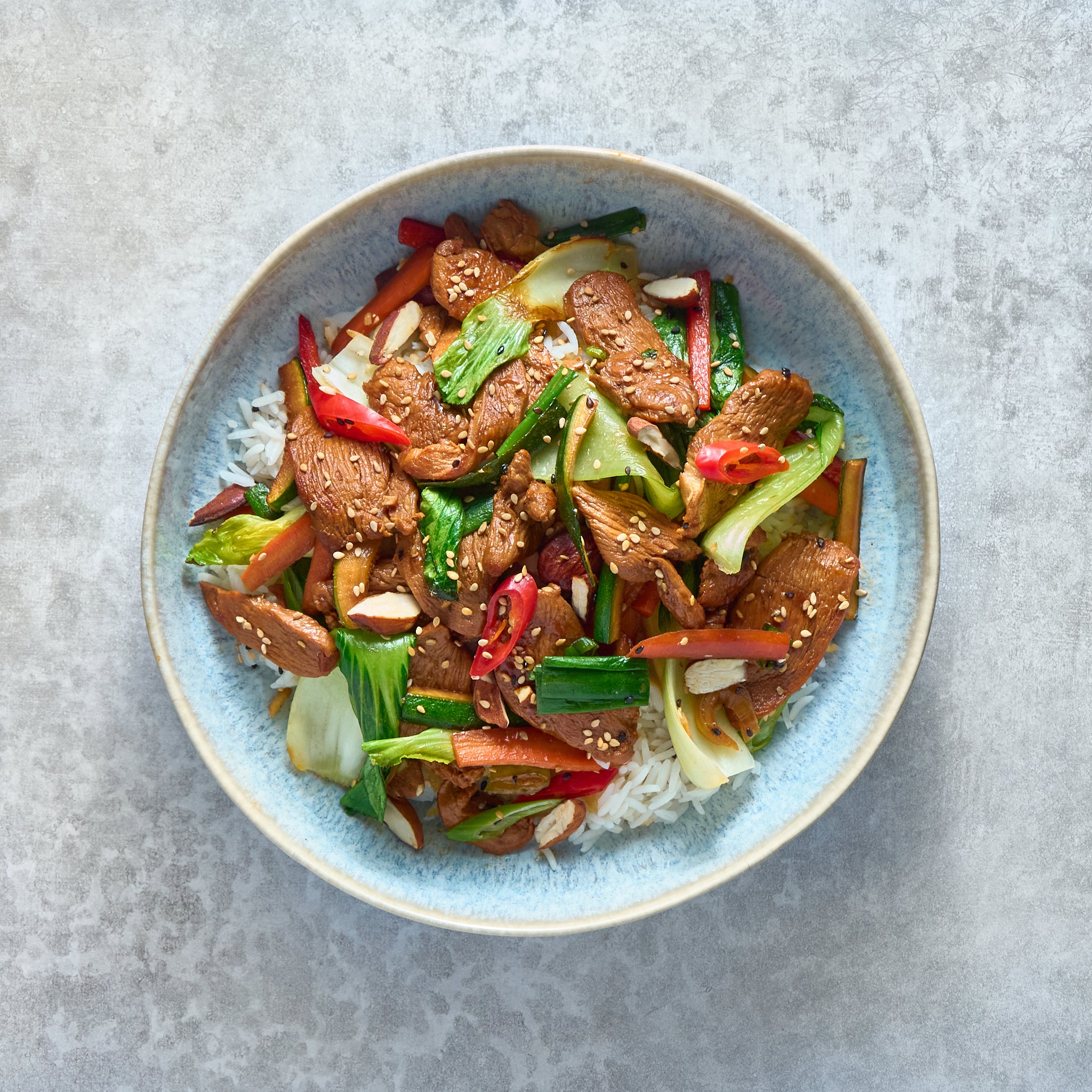 Soy Sauce Chicken Stir-Fry with Vegetables and Almonds, Served with Basmati Rice