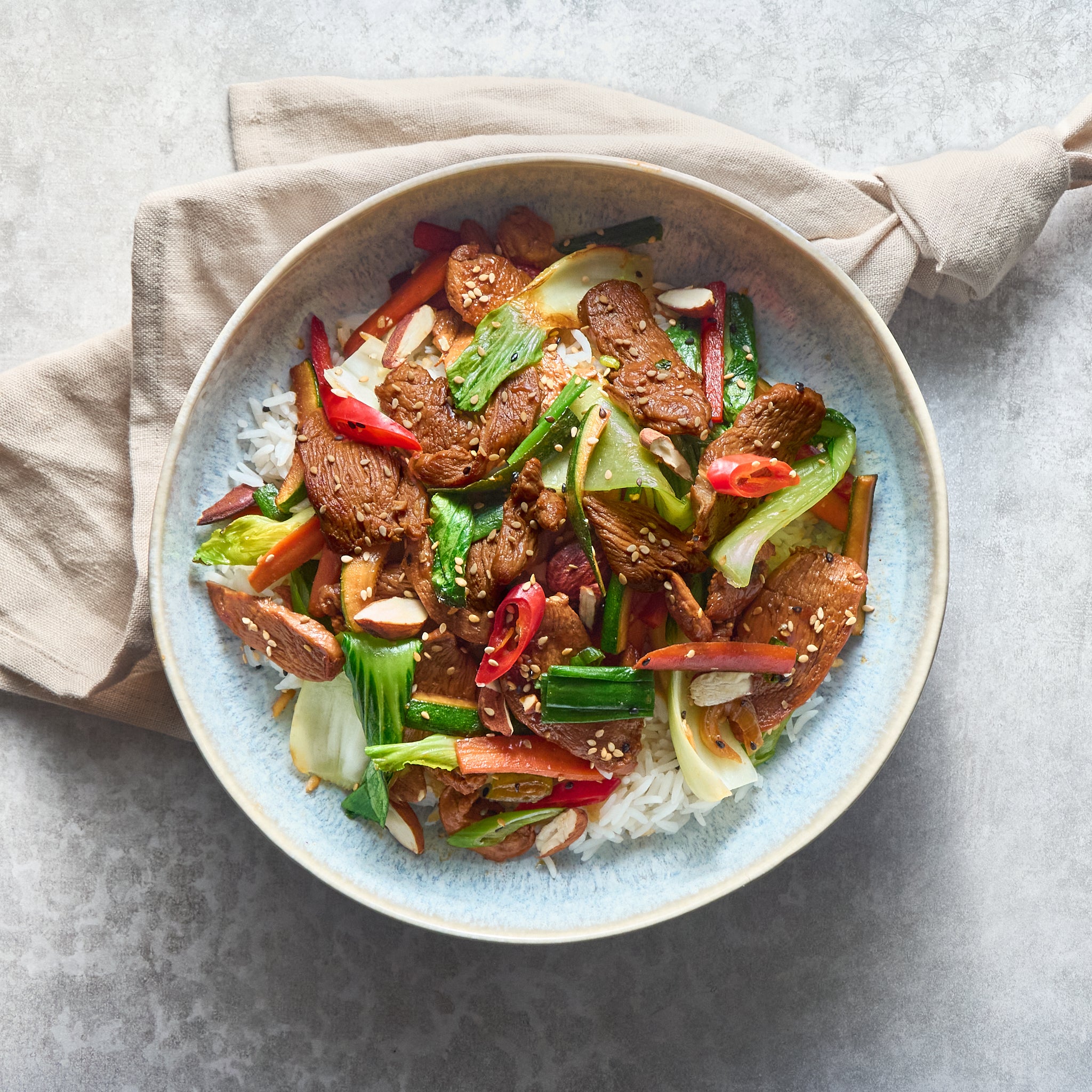 Soy Sauce Chicken Stir-Fry with Vegetables and Almonds, Served with Basmati Rice